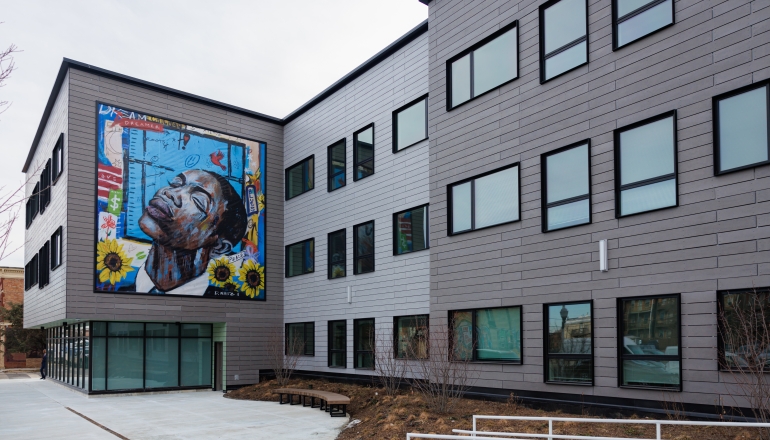 a view of Fifth City Common with mural art