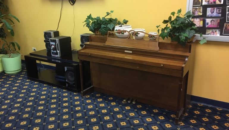Martin Farrell House activity room with piano