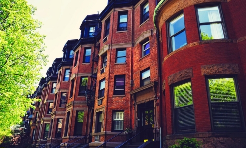 Housing lines the street of a classic Boston neighborhood. Photo via Pixabay