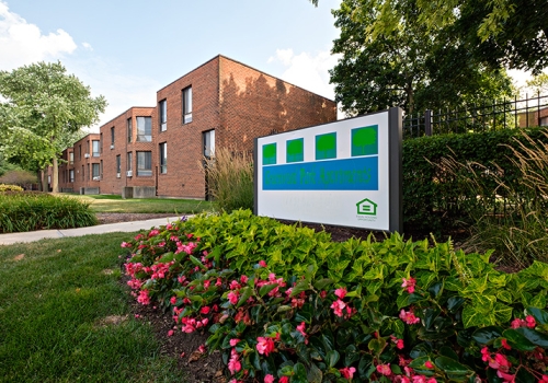 Greenwood Park Apartments sign and flowers