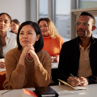 Folks attending a class and taking notes.